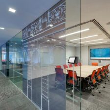 A conference room with a video display and in-ceiling speakers.