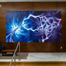 A video wall in a lobby displaying a beautiful blue-violet image.